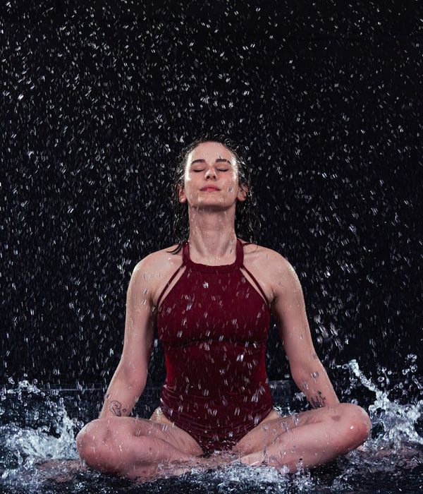 Person in a dynamic yet calm motion pose indoors.